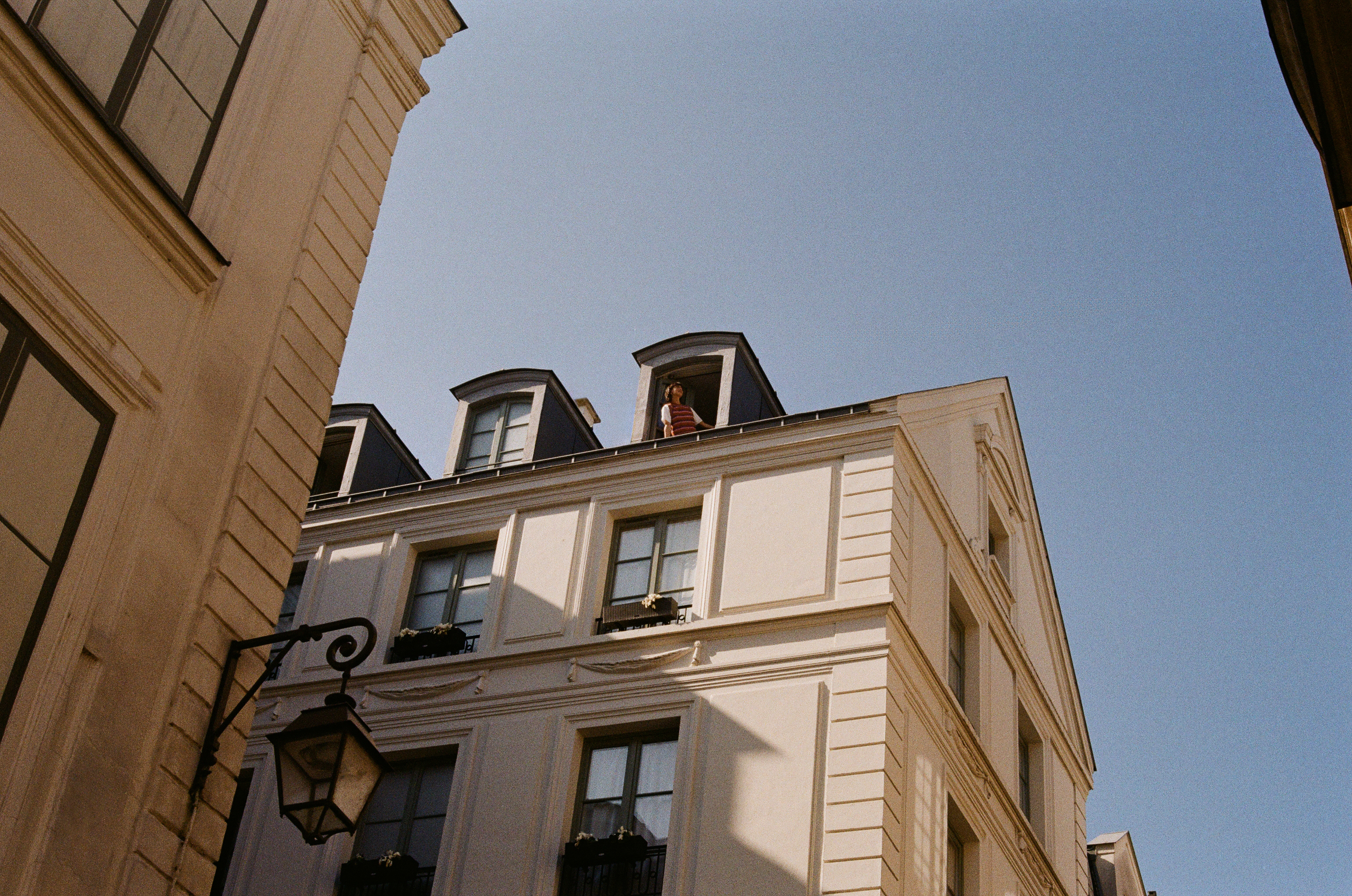 a person standing on a balcony of a building
