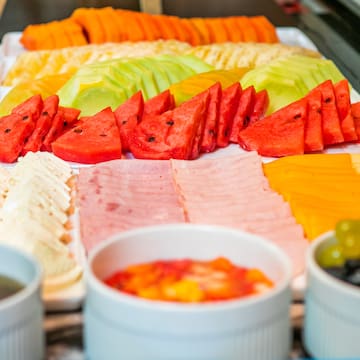 a plate of fruit and dips