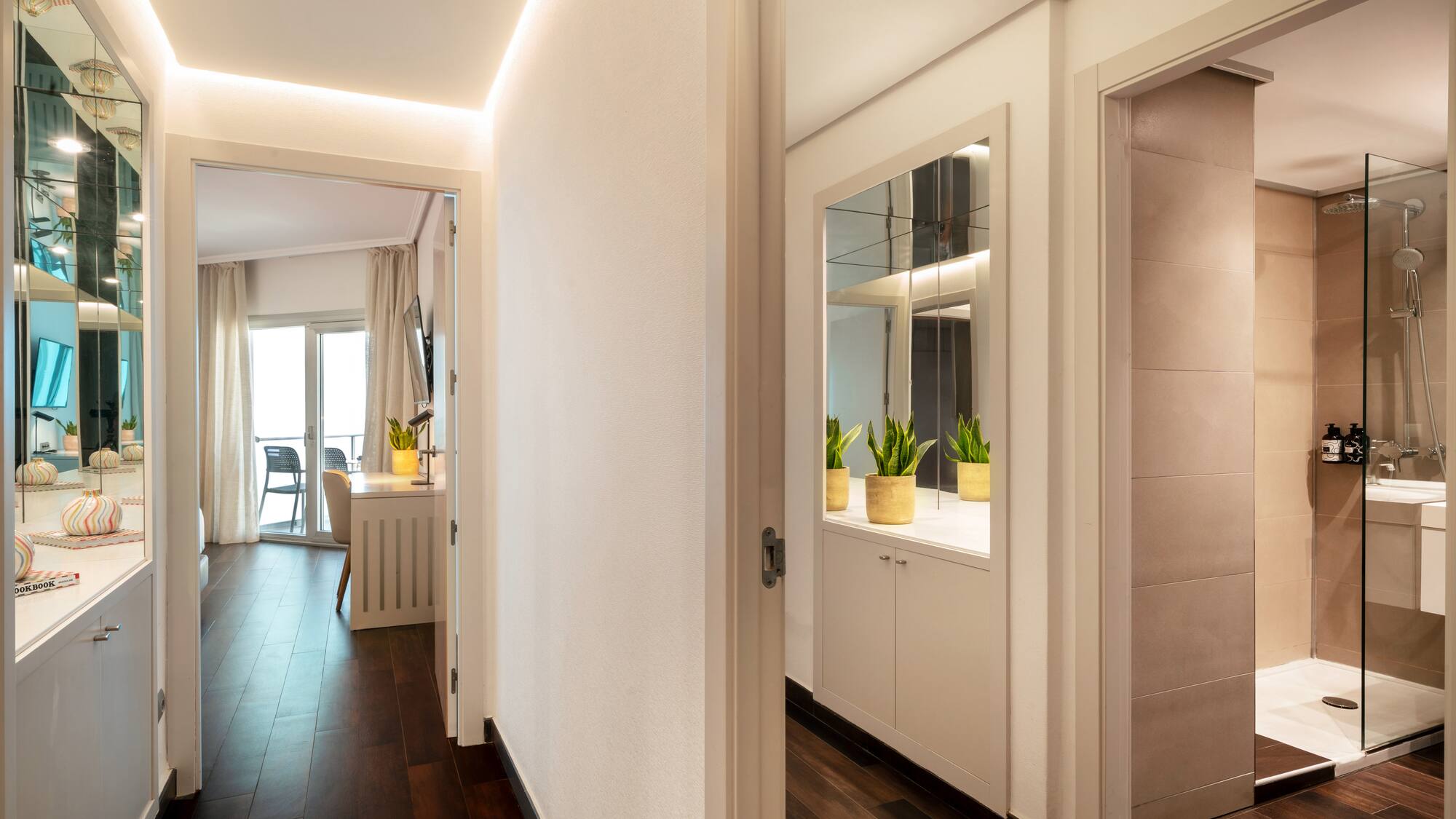 a hallway with a door open and a mirror