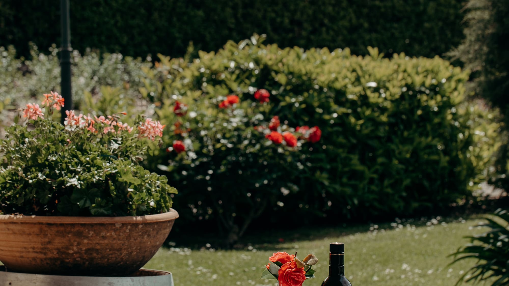 a table with wine glasses and a bottle of wine