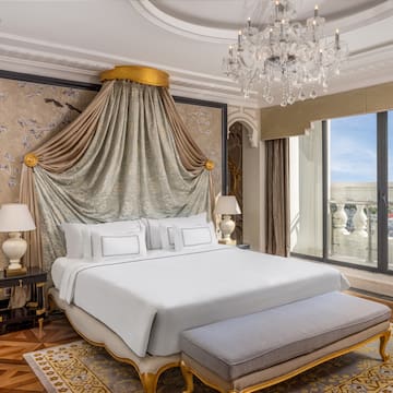 a bedroom with a bed and chandelier