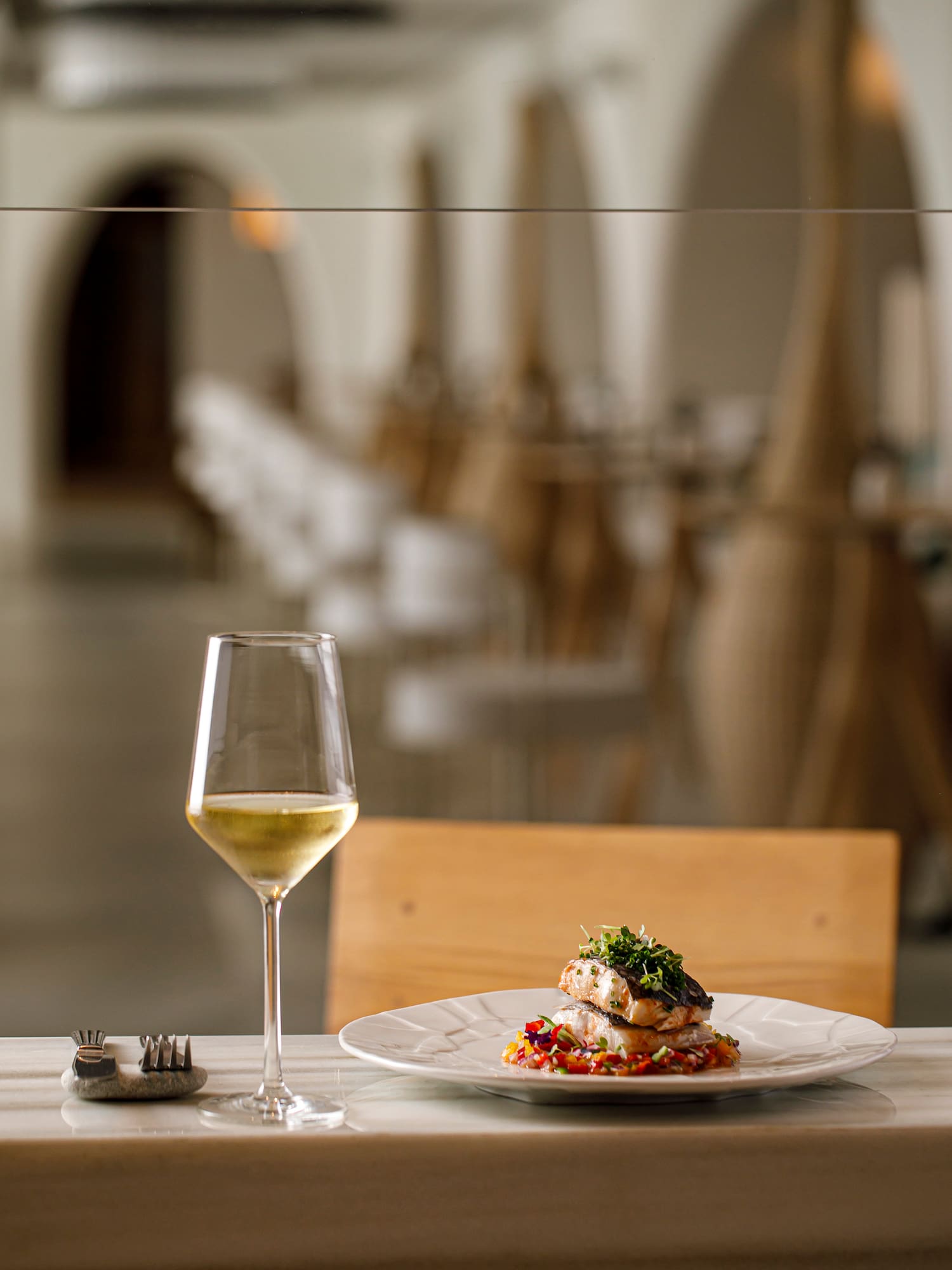 a plate of food and a glass of wine