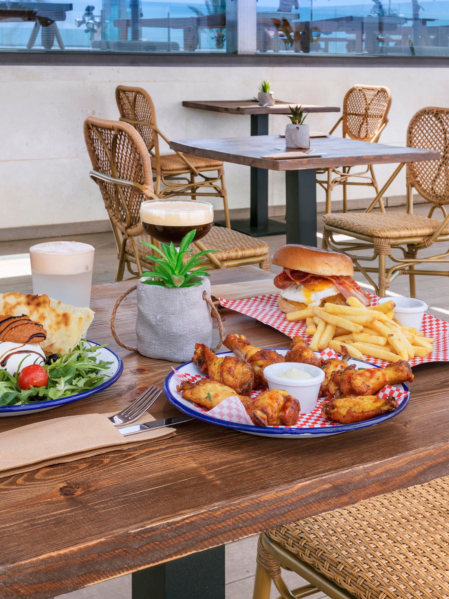 a table with plates of food and drinks