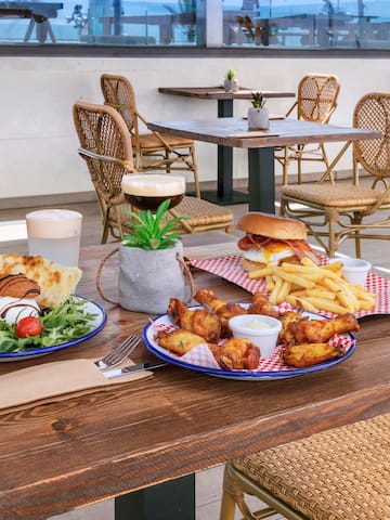 a table with plates of food and drinks