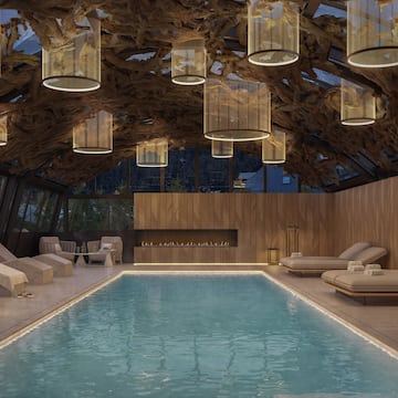 a indoor pool with a large ceiling and chandeliers