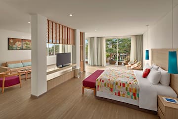 a bedroom with a bed and a television