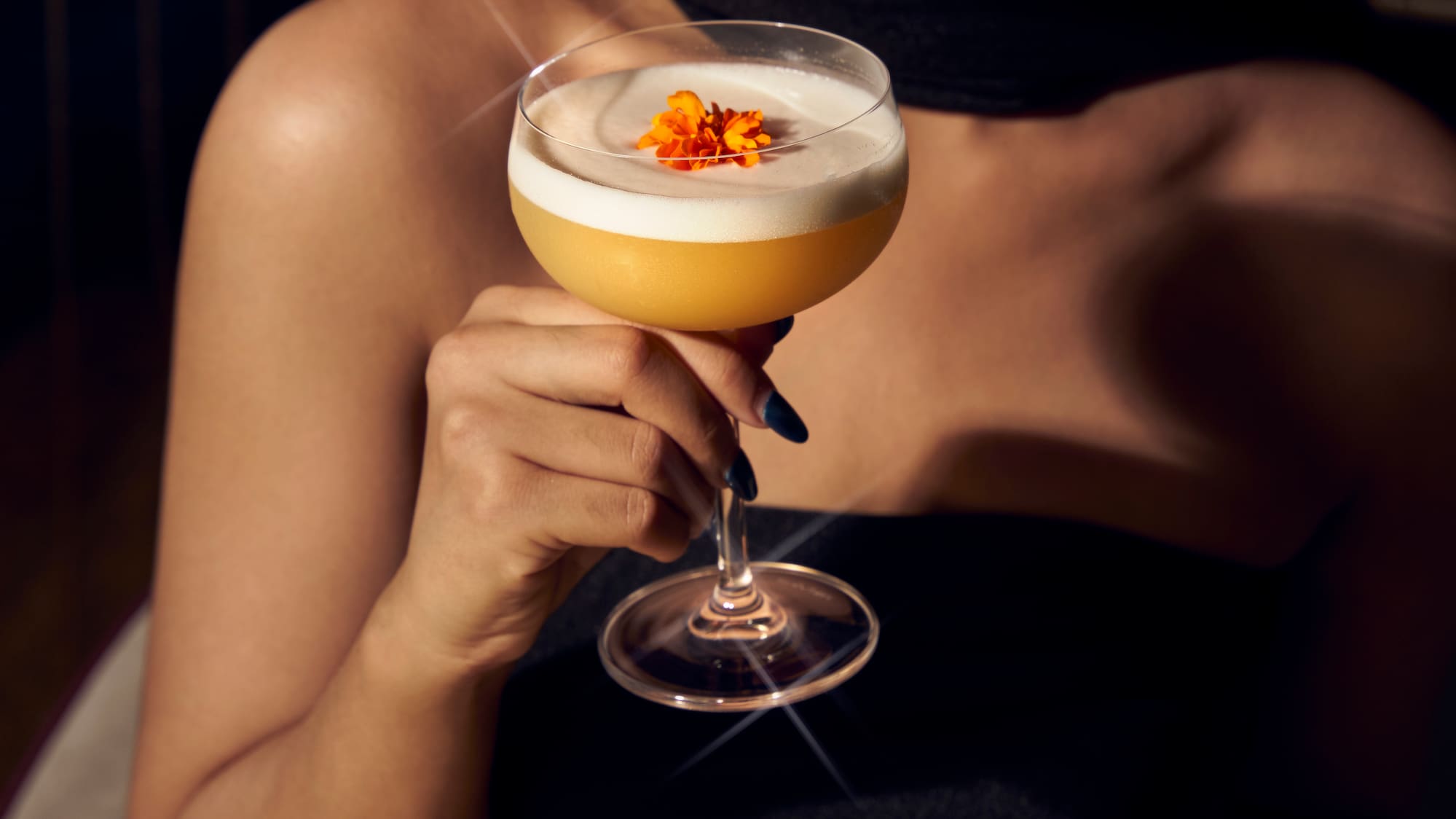 a woman holding a glass of drink