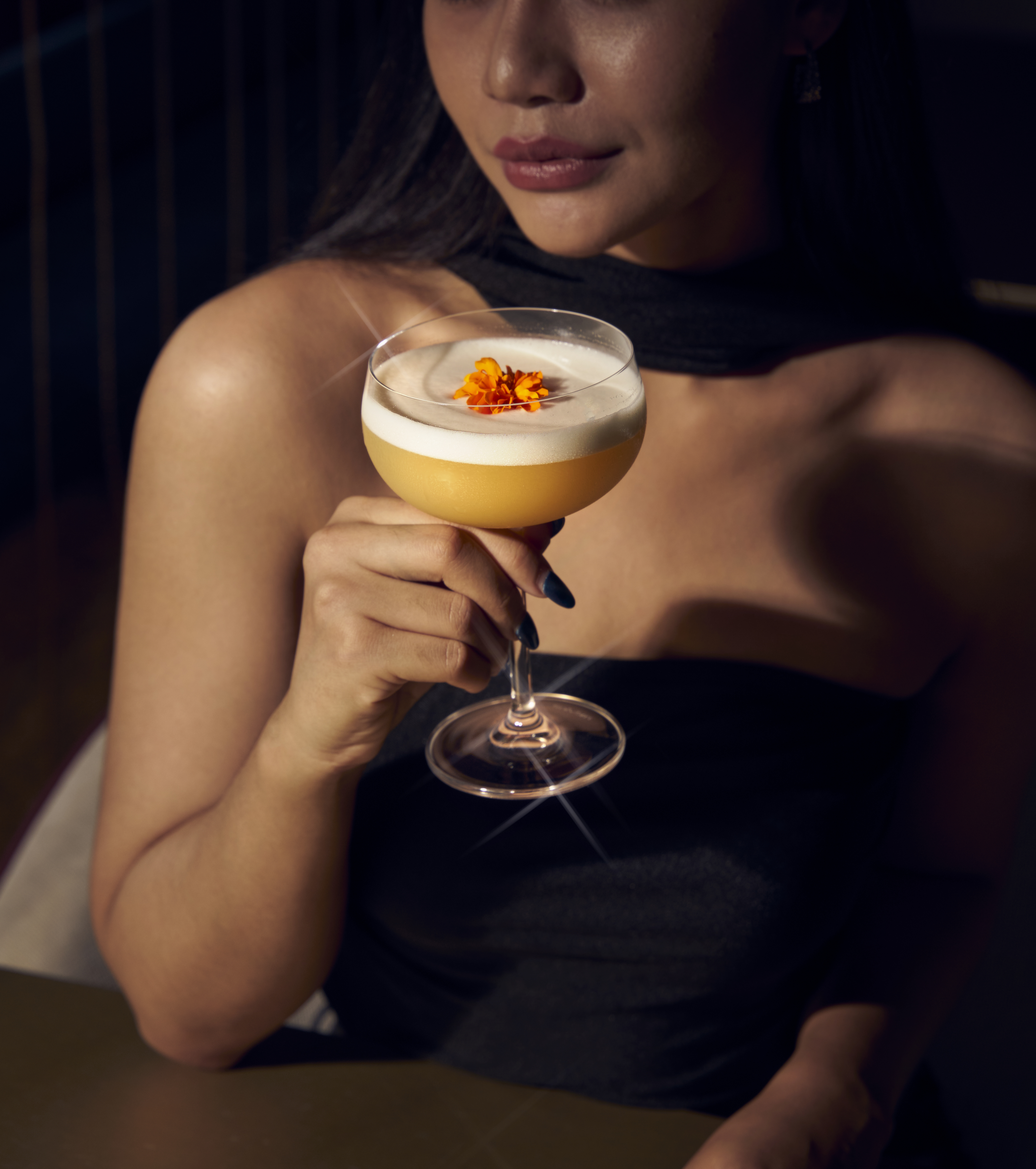 a woman drinking a drink in front of a city
