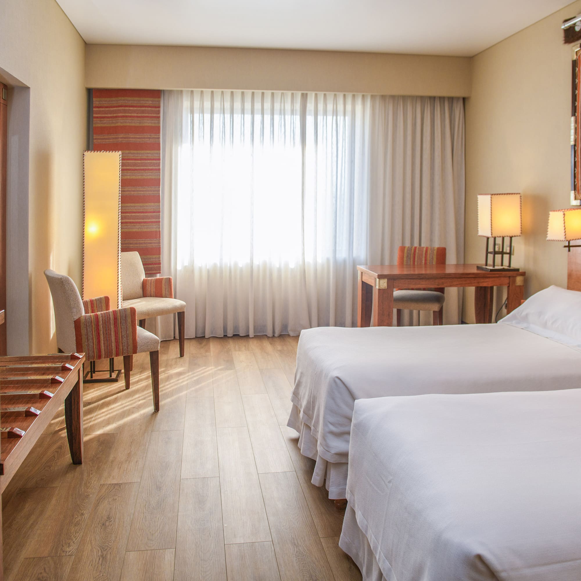 a room with two beds and a piano