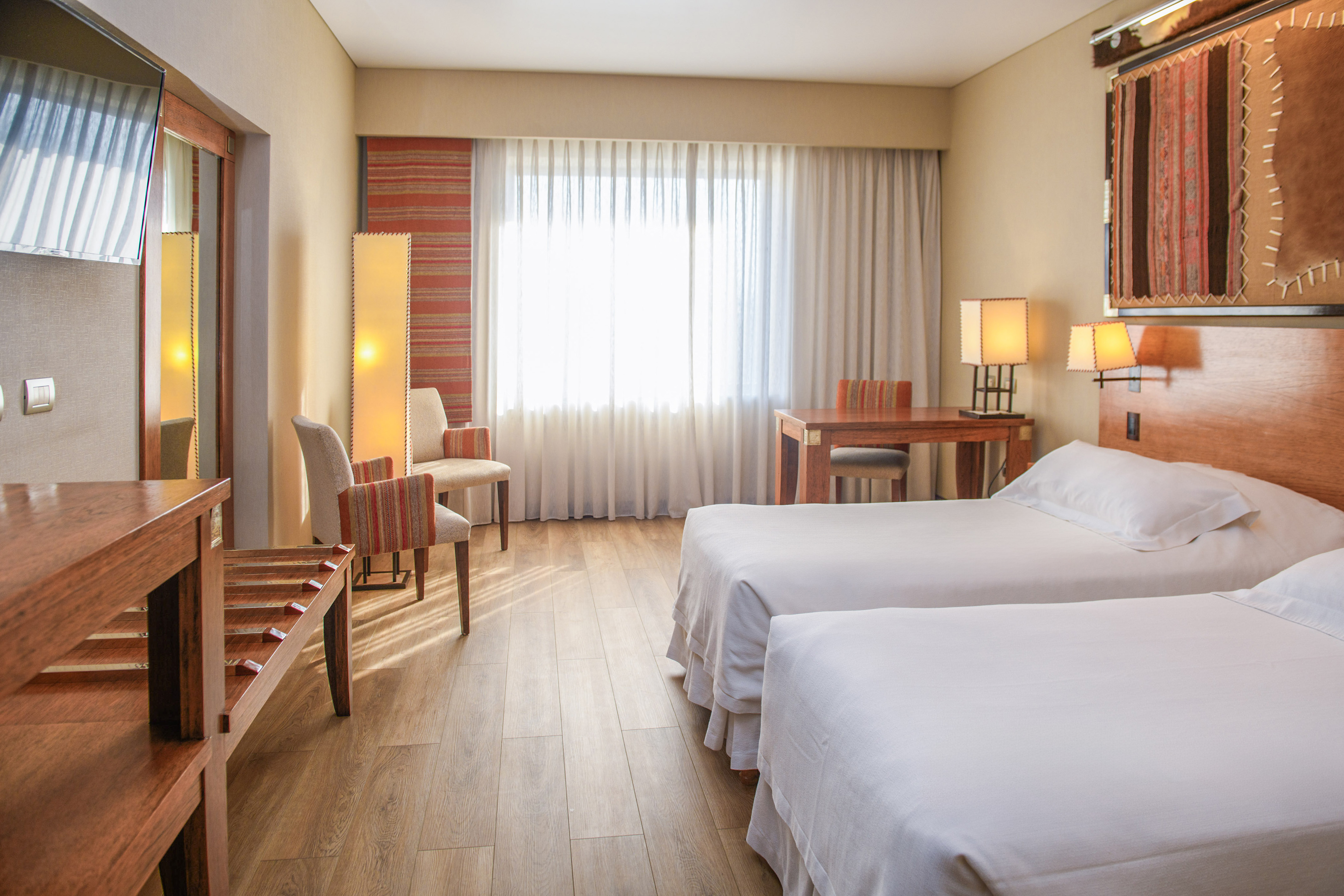 a room with two beds and a piano