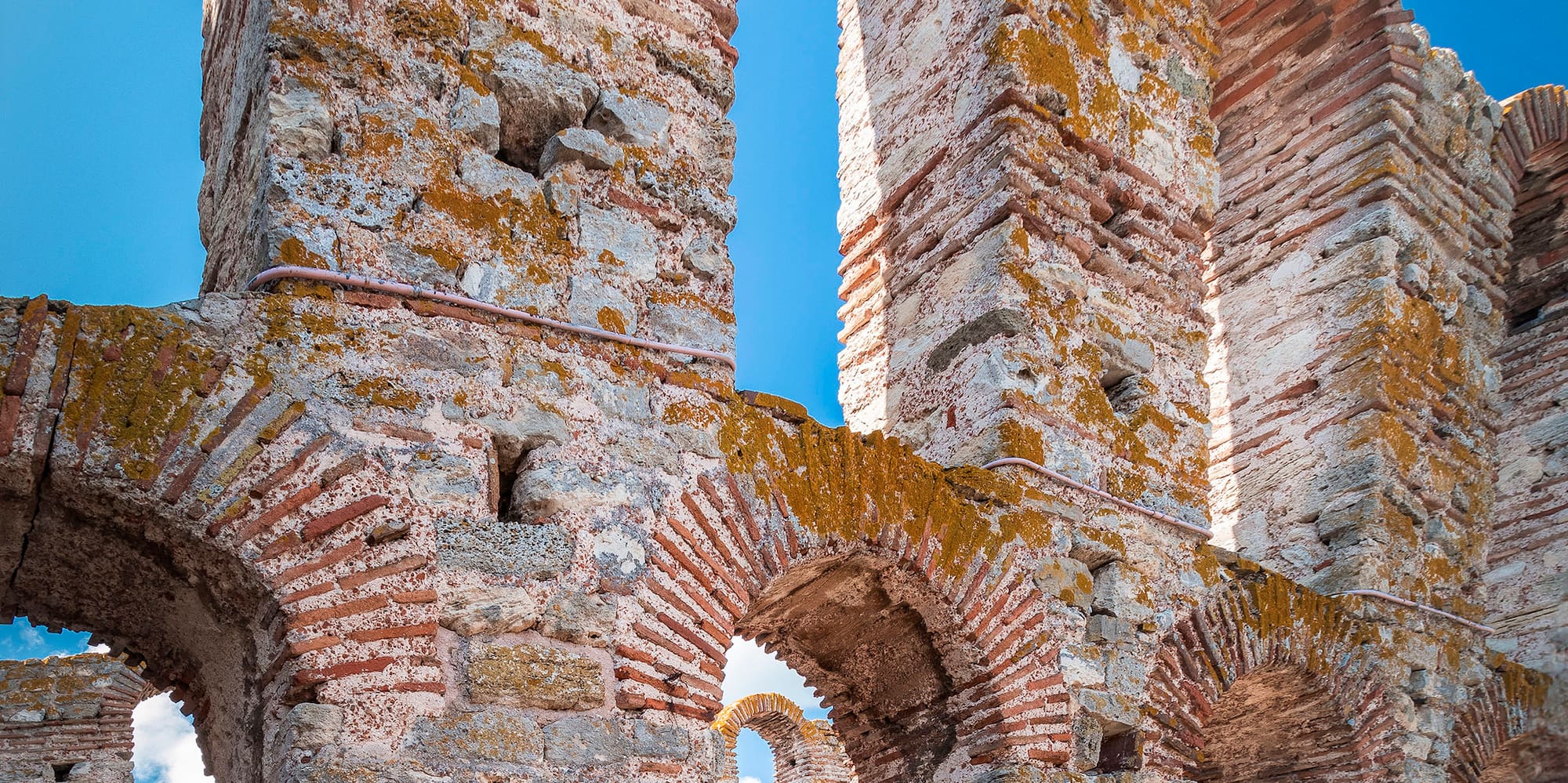 a stone wall with arches