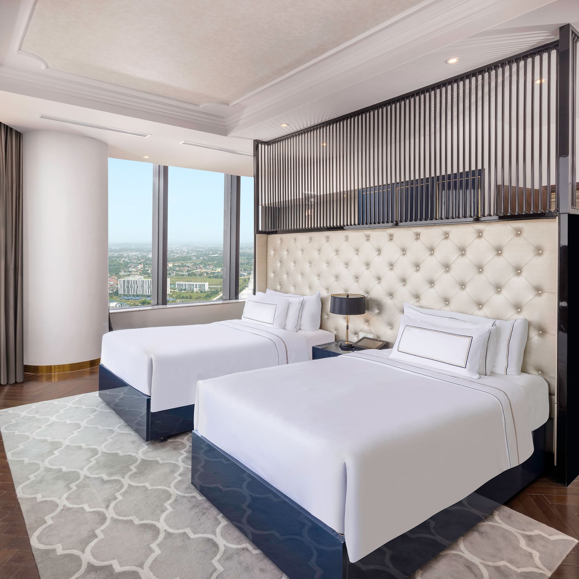 a room with two beds and a view of a city