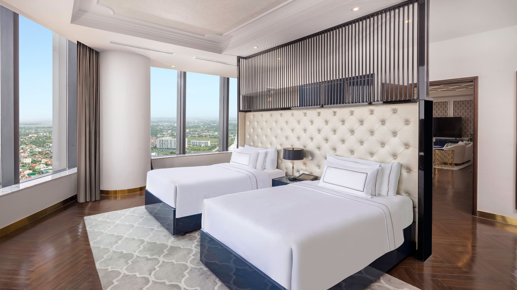 a room with two beds and a view of a city