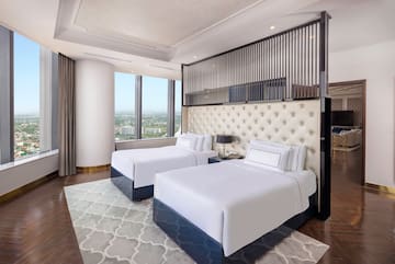 a room with two beds and a view of a city