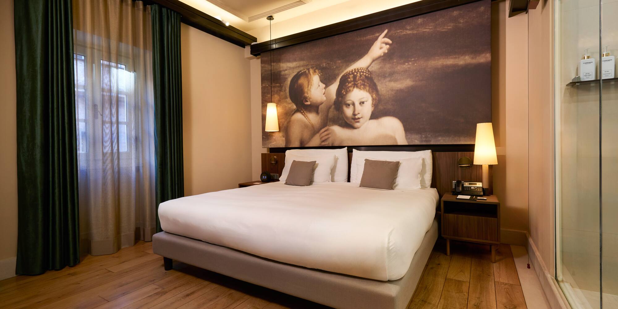 a bed with a painting above it