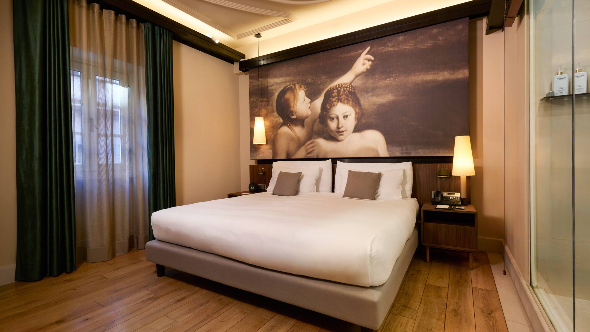 a bed with a painting above it