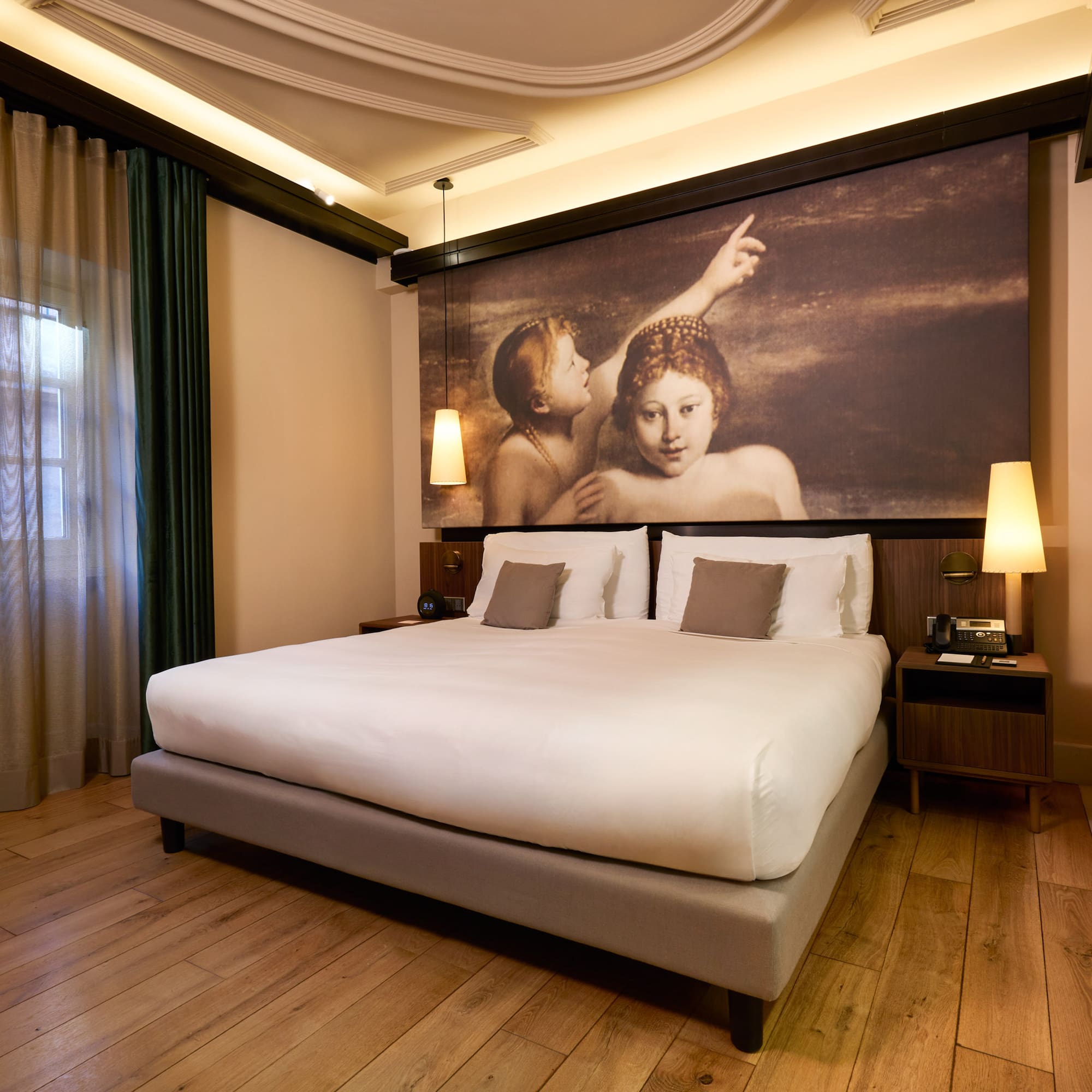 a bed with a painting above it