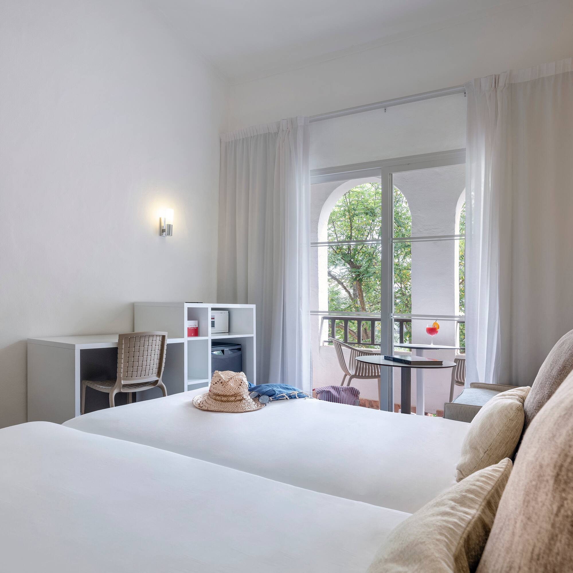 a room with two beds and a balcony