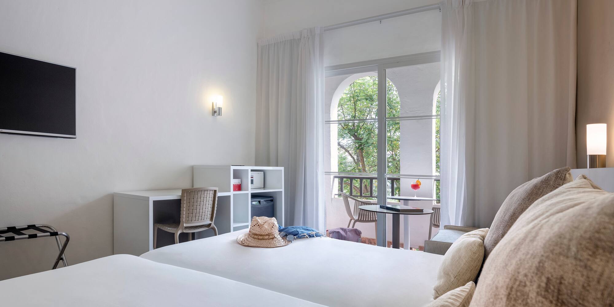 a room with two beds and a balcony