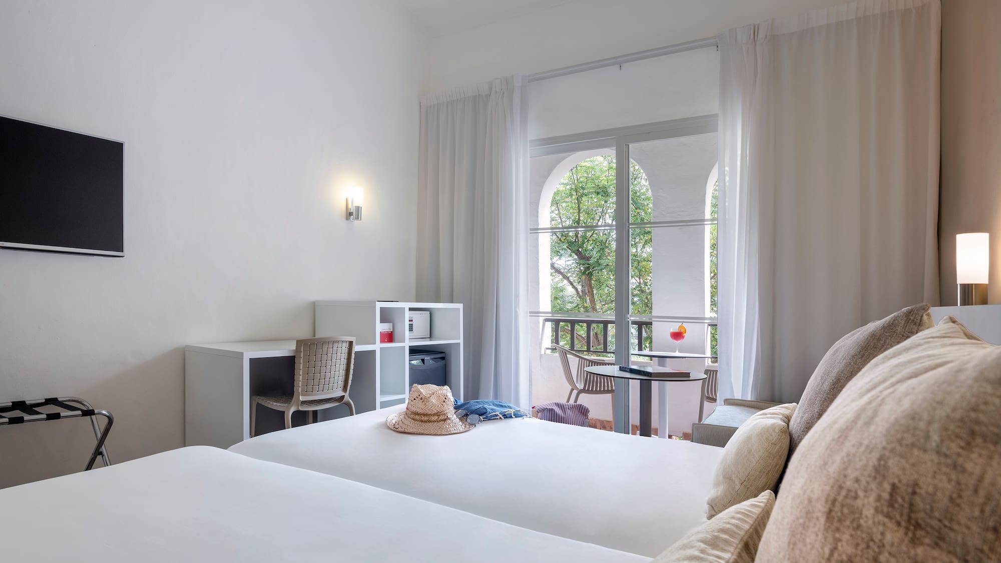 a room with two beds and a balcony