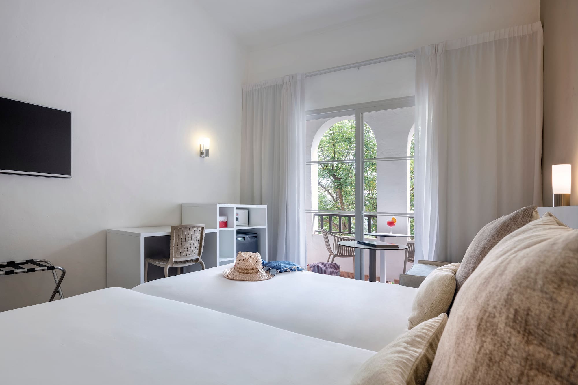 a room with two beds and a balcony