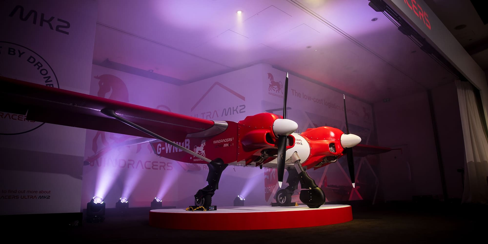 a red and white airplane on a stage