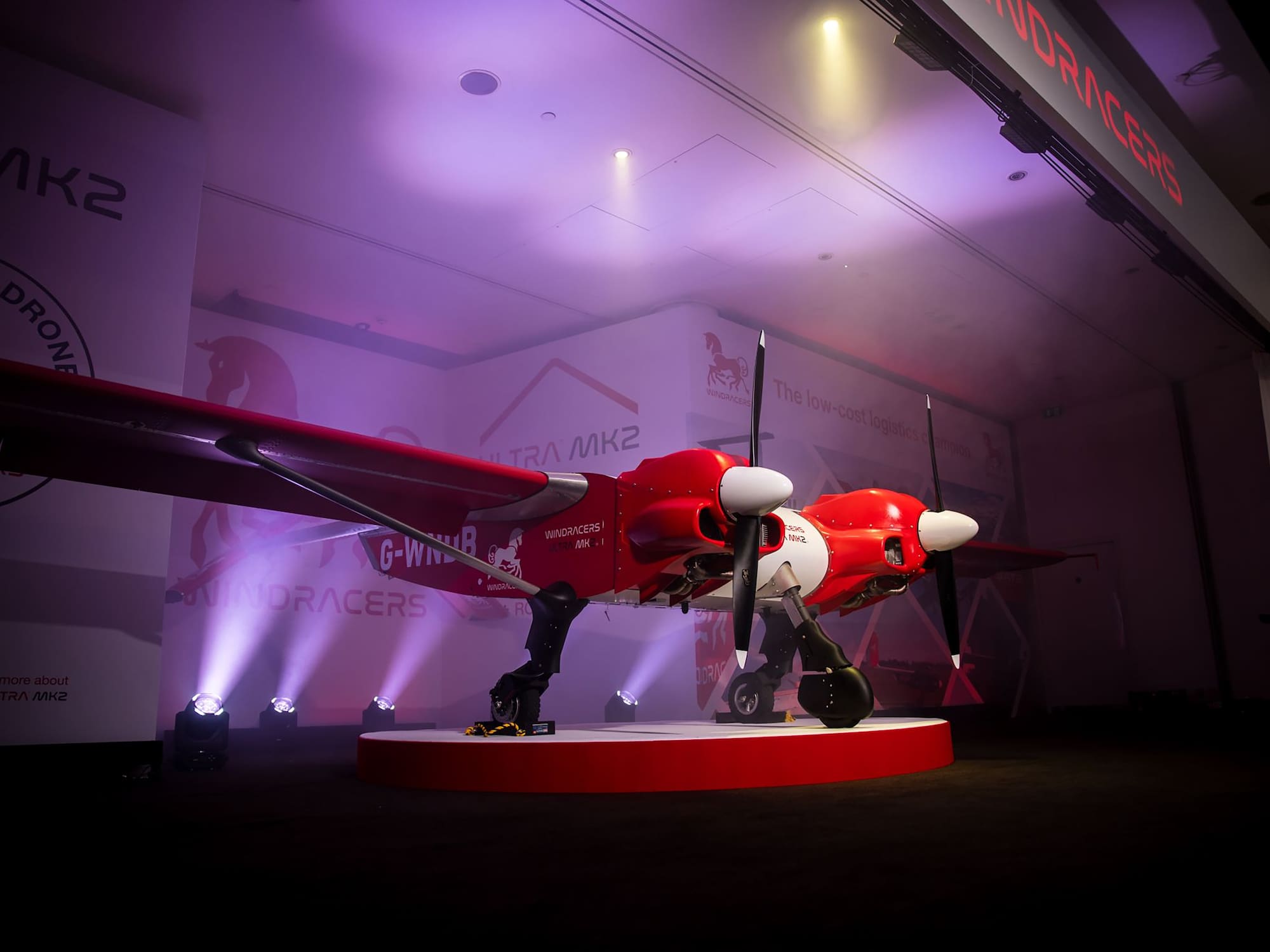 a red and white airplane on a stage