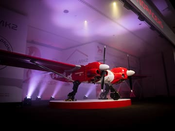 a red and white airplane on a stage