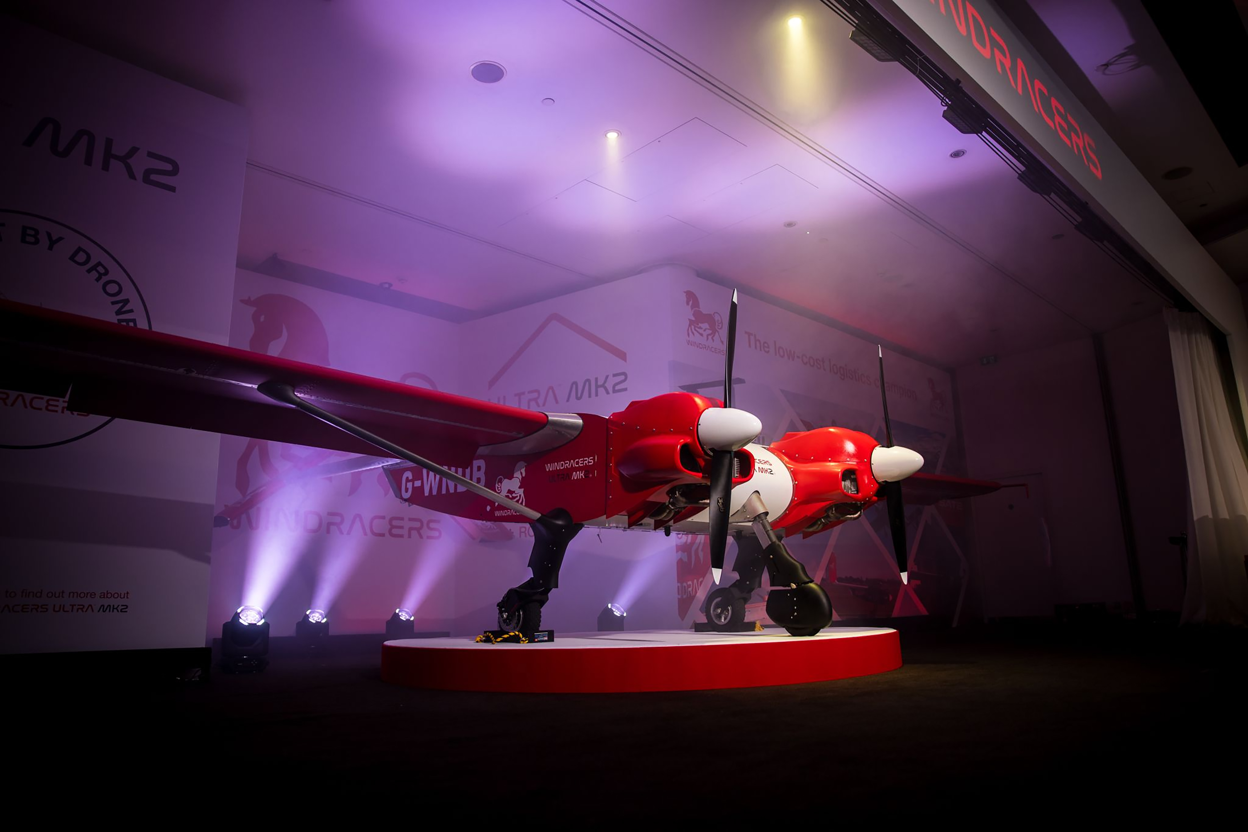 a red and white airplane on a stage