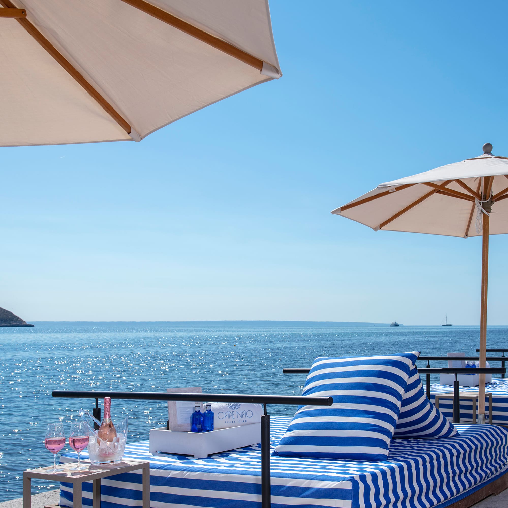 a beach with umbrellas and a bed