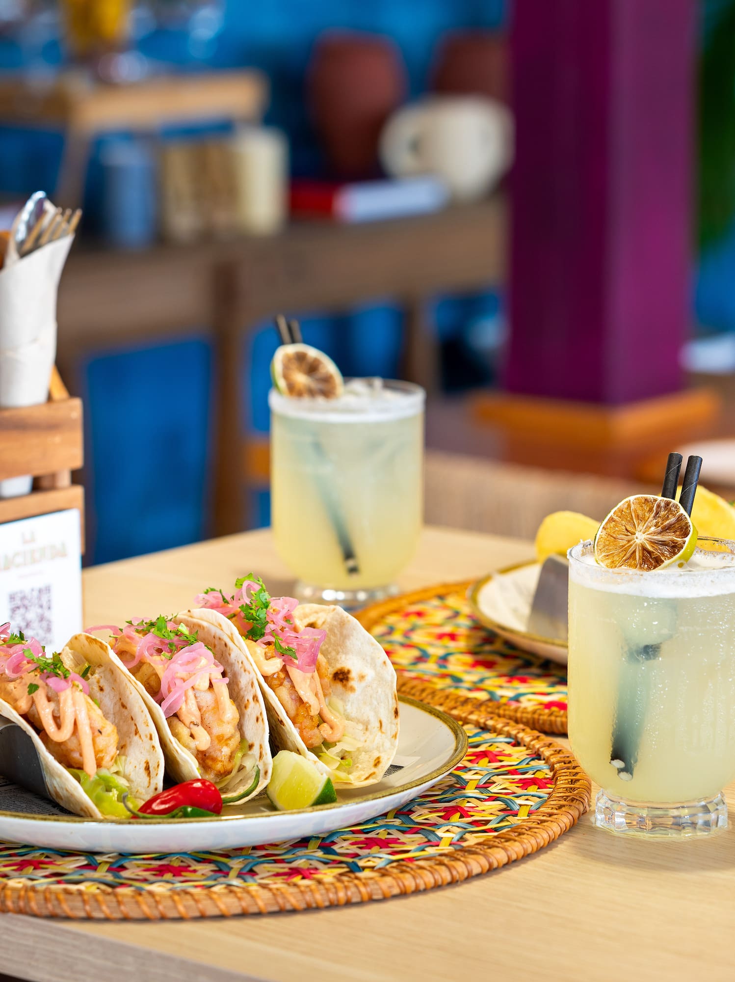 a plate of tacos and drinks on a table