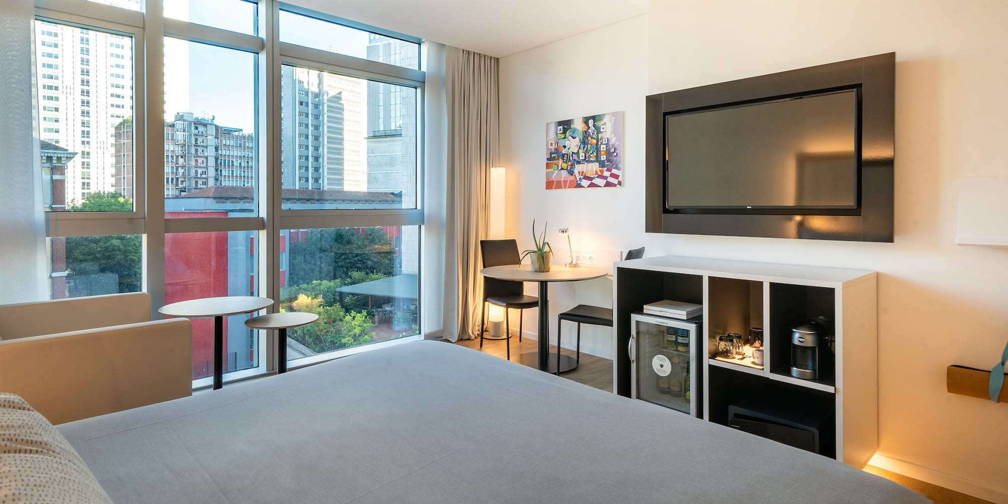 a room with a bed and a television