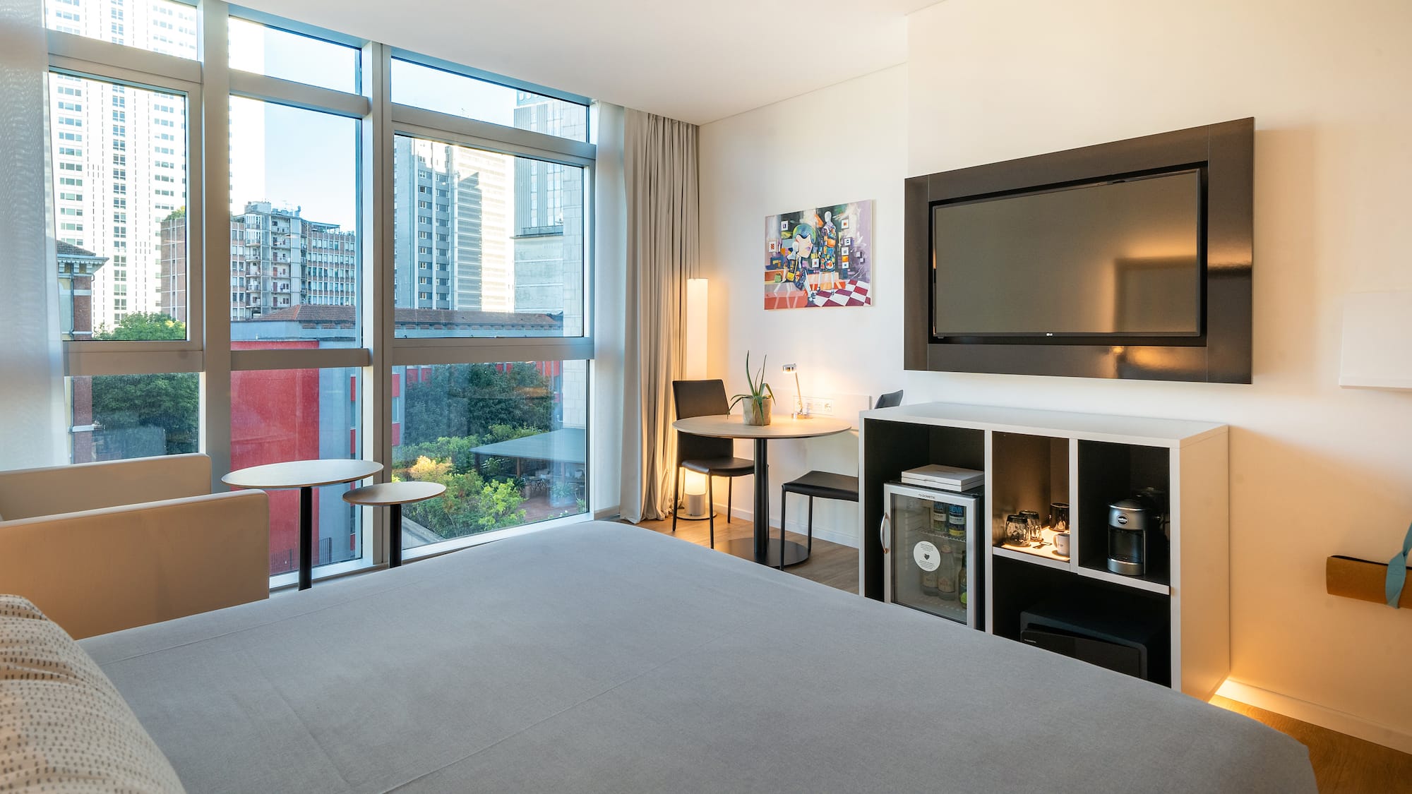 a room with a bed and a television