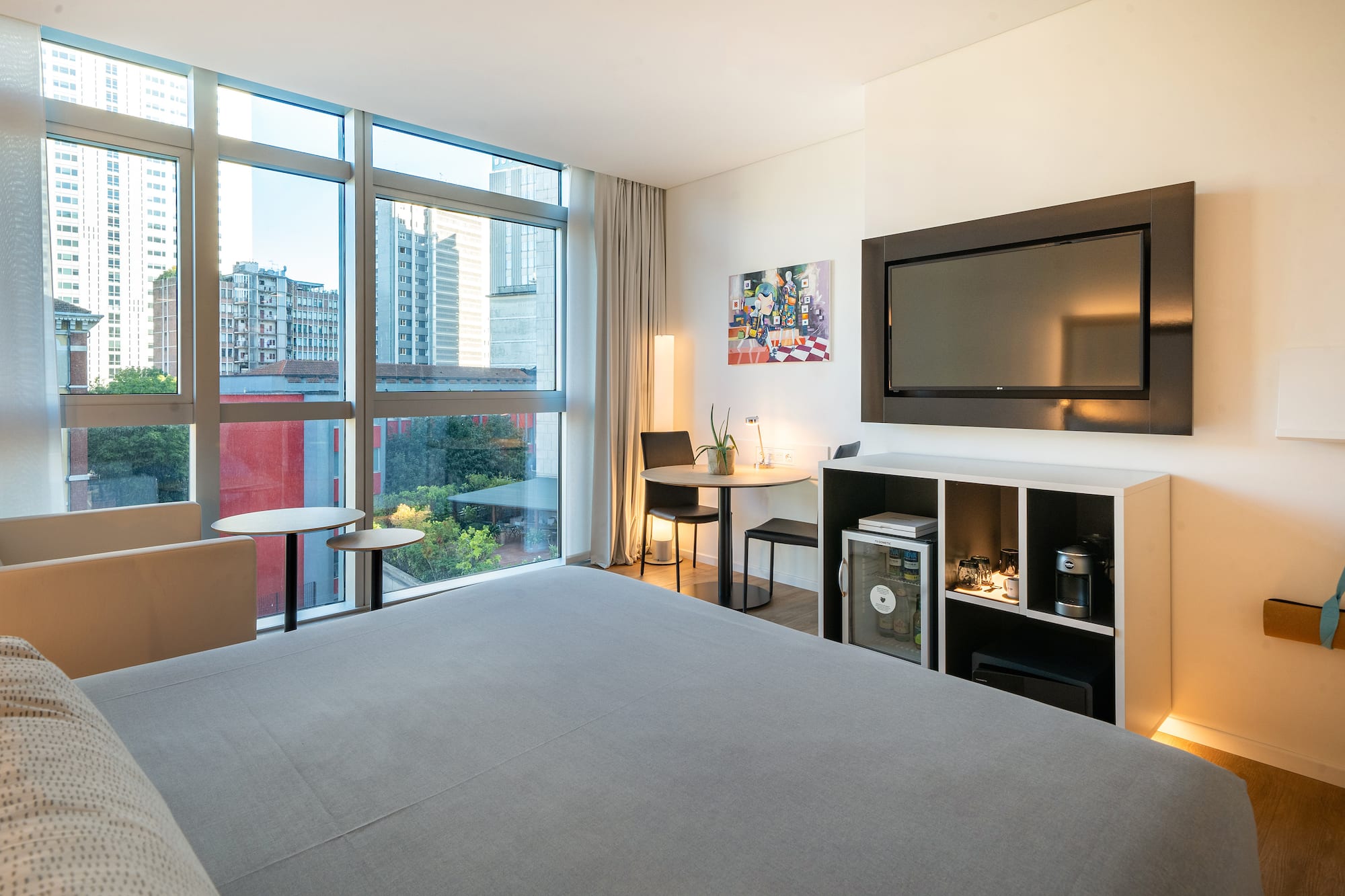 a room with a bed and a television