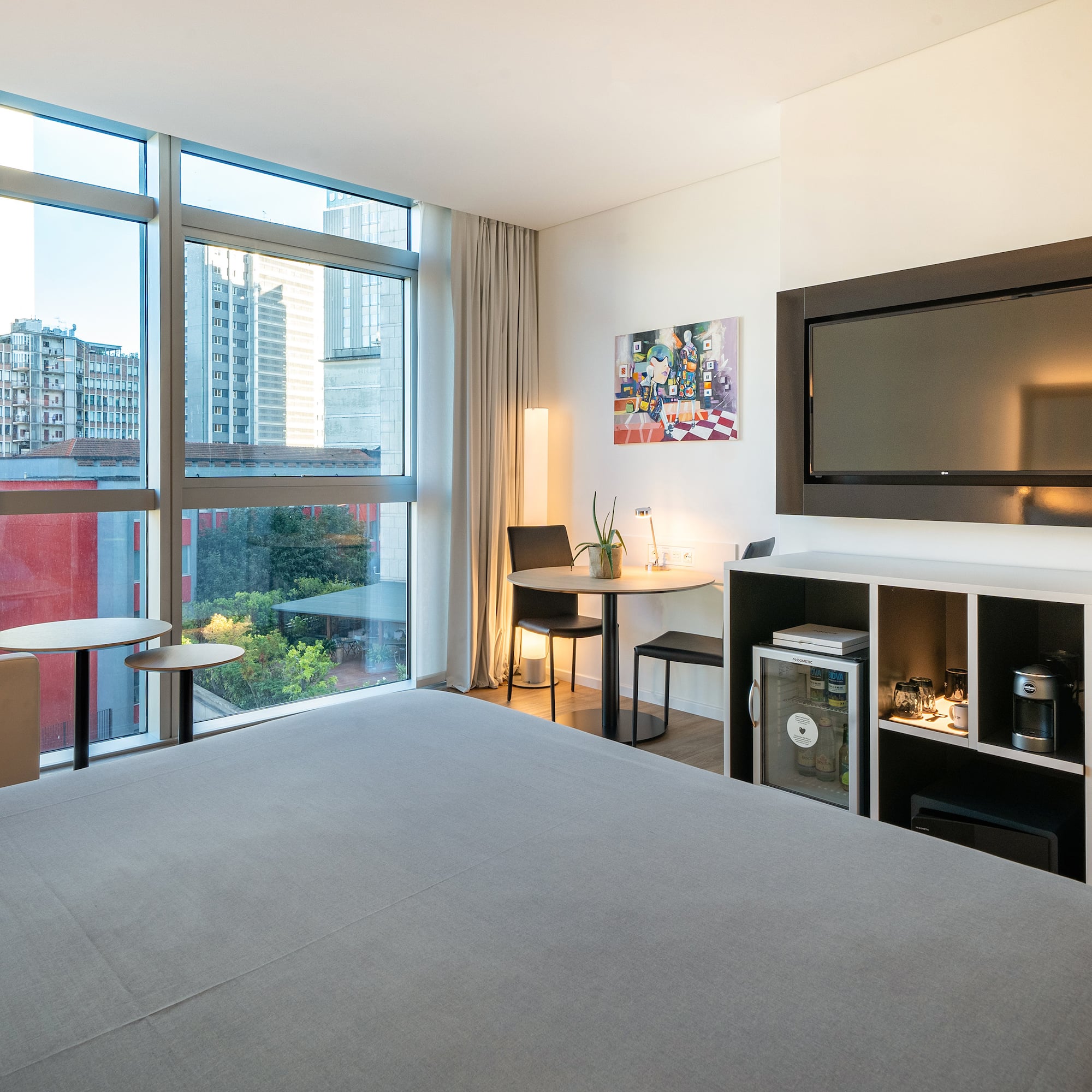 a room with a bed and a television