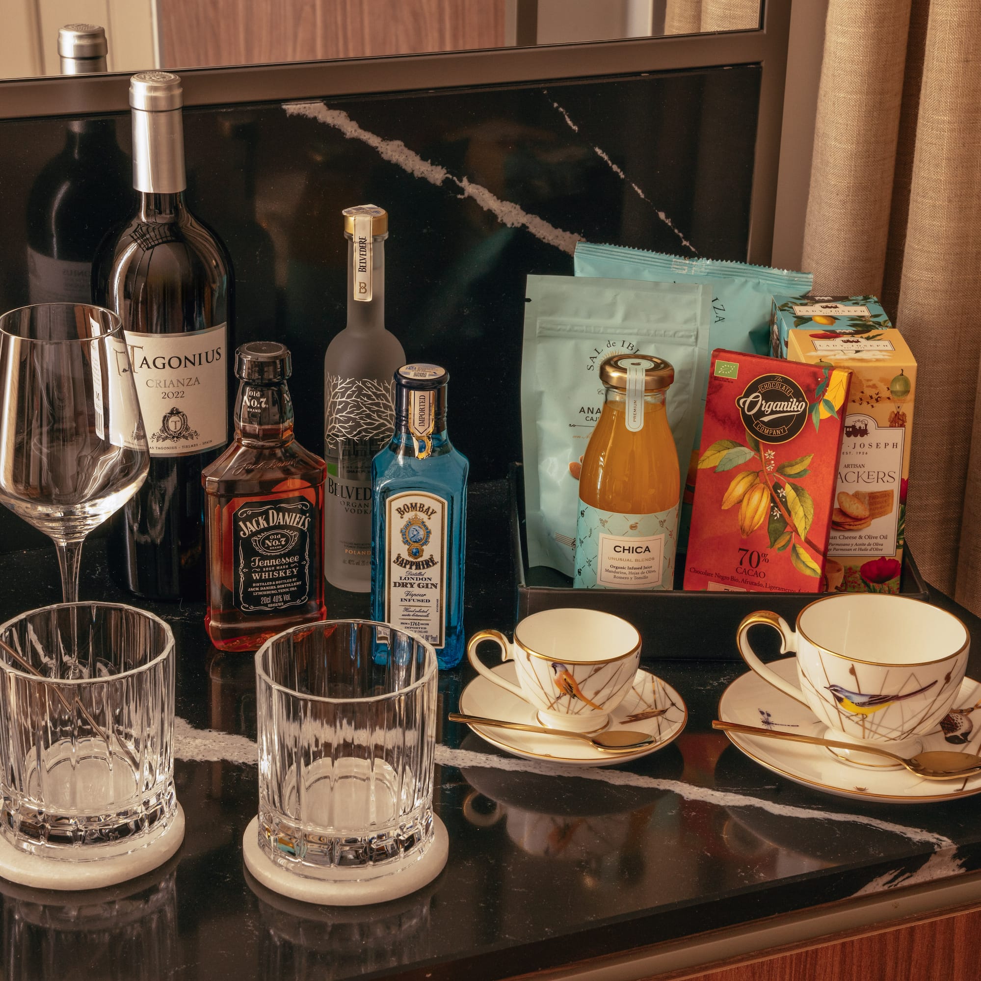 a table with a group of glasses and bottles of liquor