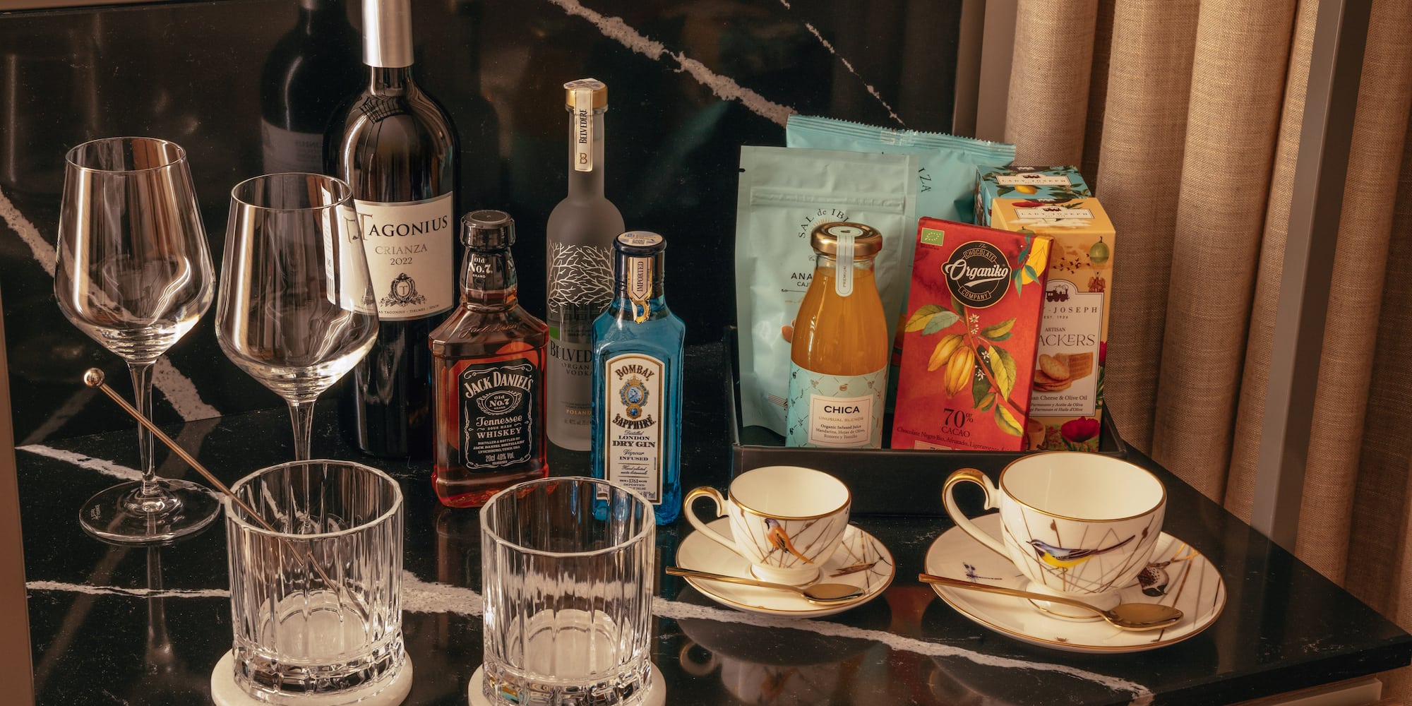 a table with a group of glasses and bottles of liquor