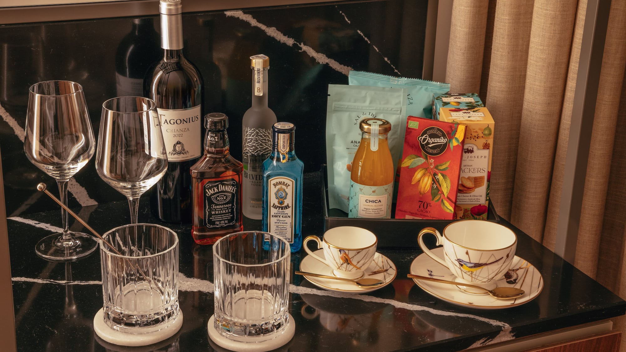 a table with a group of glasses and bottles of liquor
