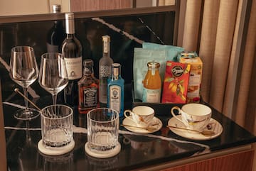 a table with a group of glasses and bottles of liquor