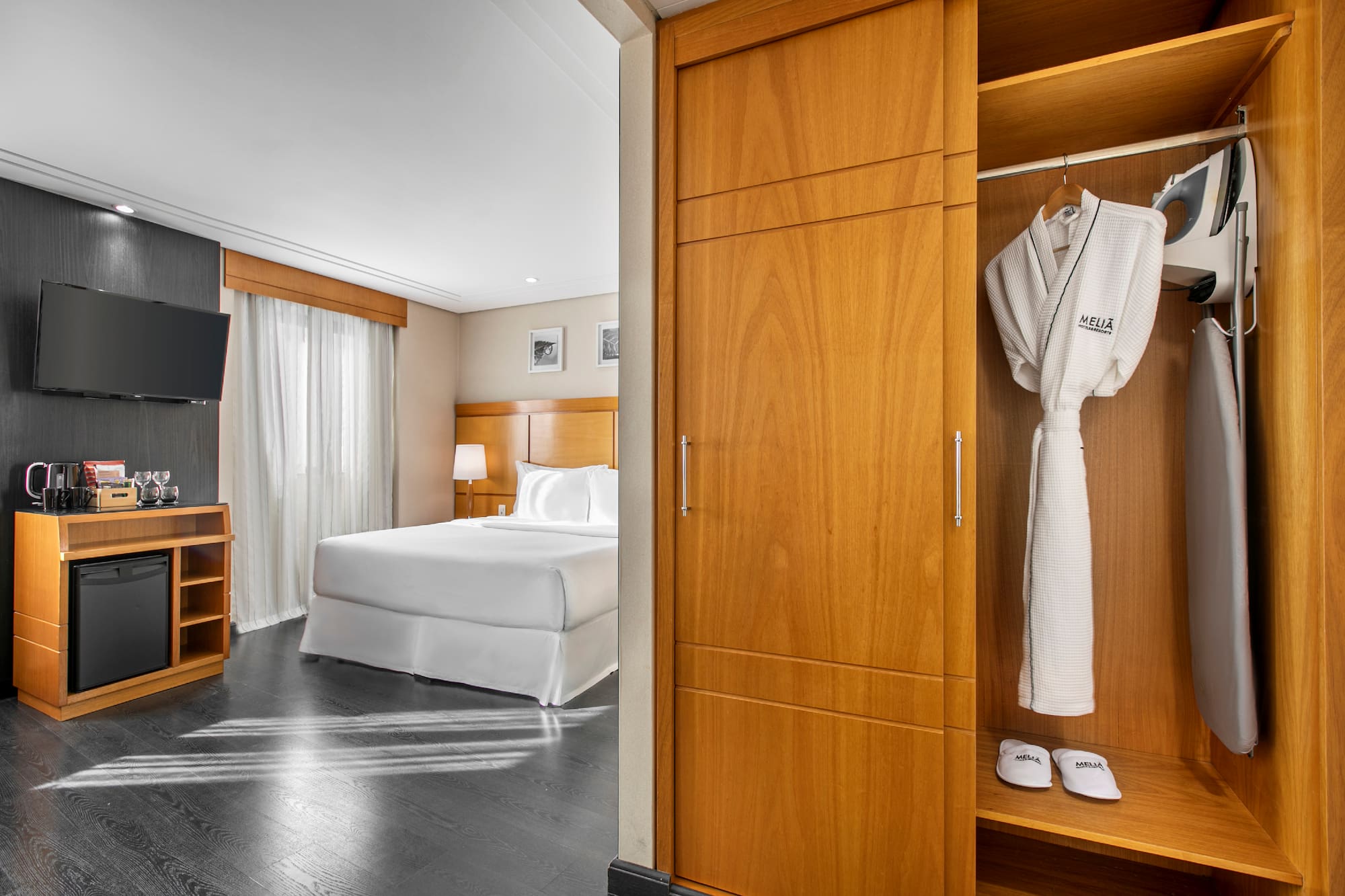 a room with a bed and a white robe