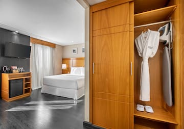 a room with a bed and a white robe