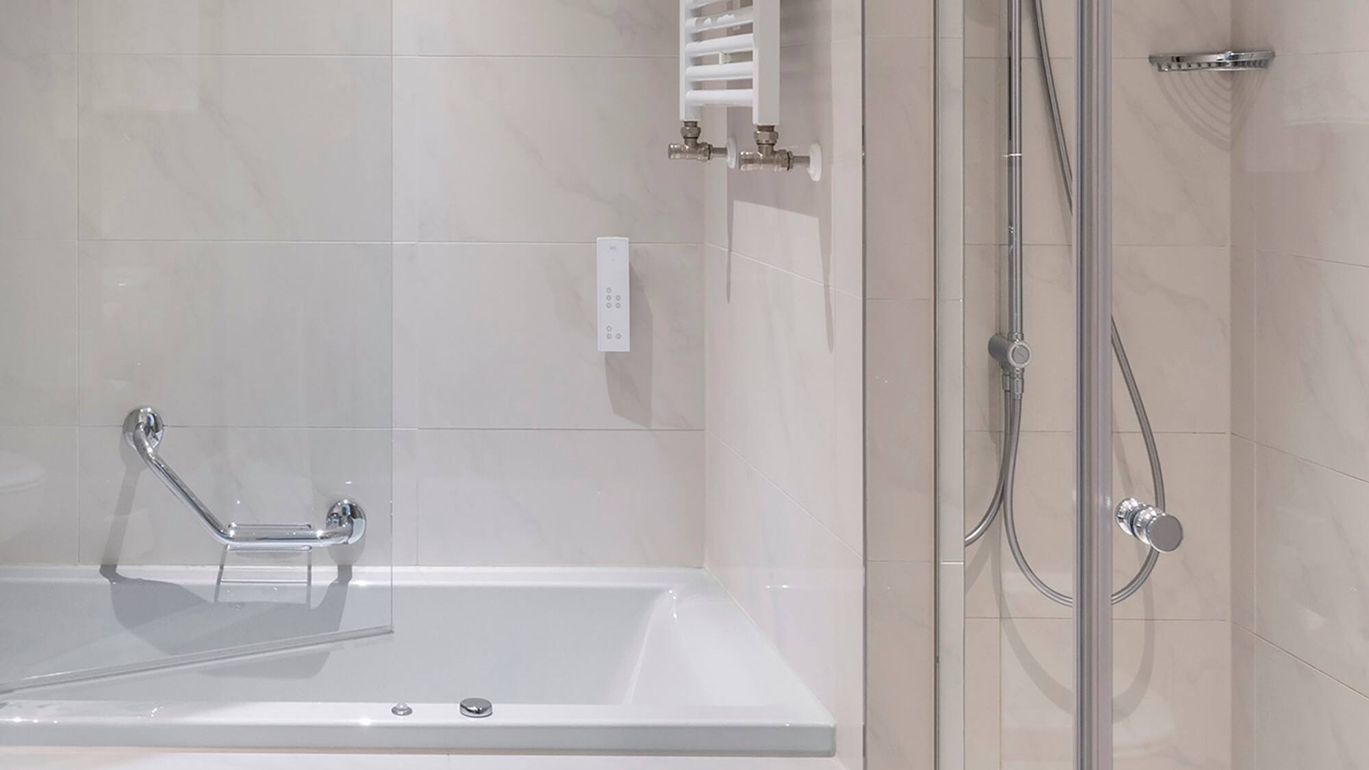 a bathroom with a bathtub and shower