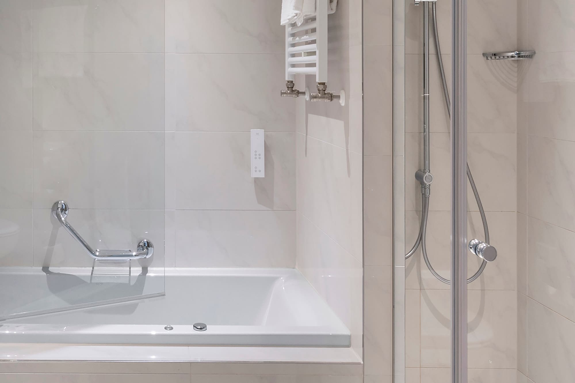 a bathroom with a bathtub and shower