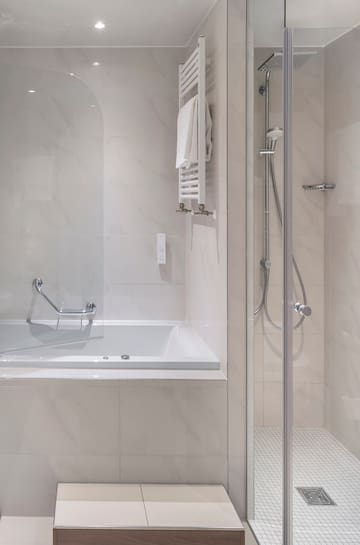 a bathroom with a bathtub and shower