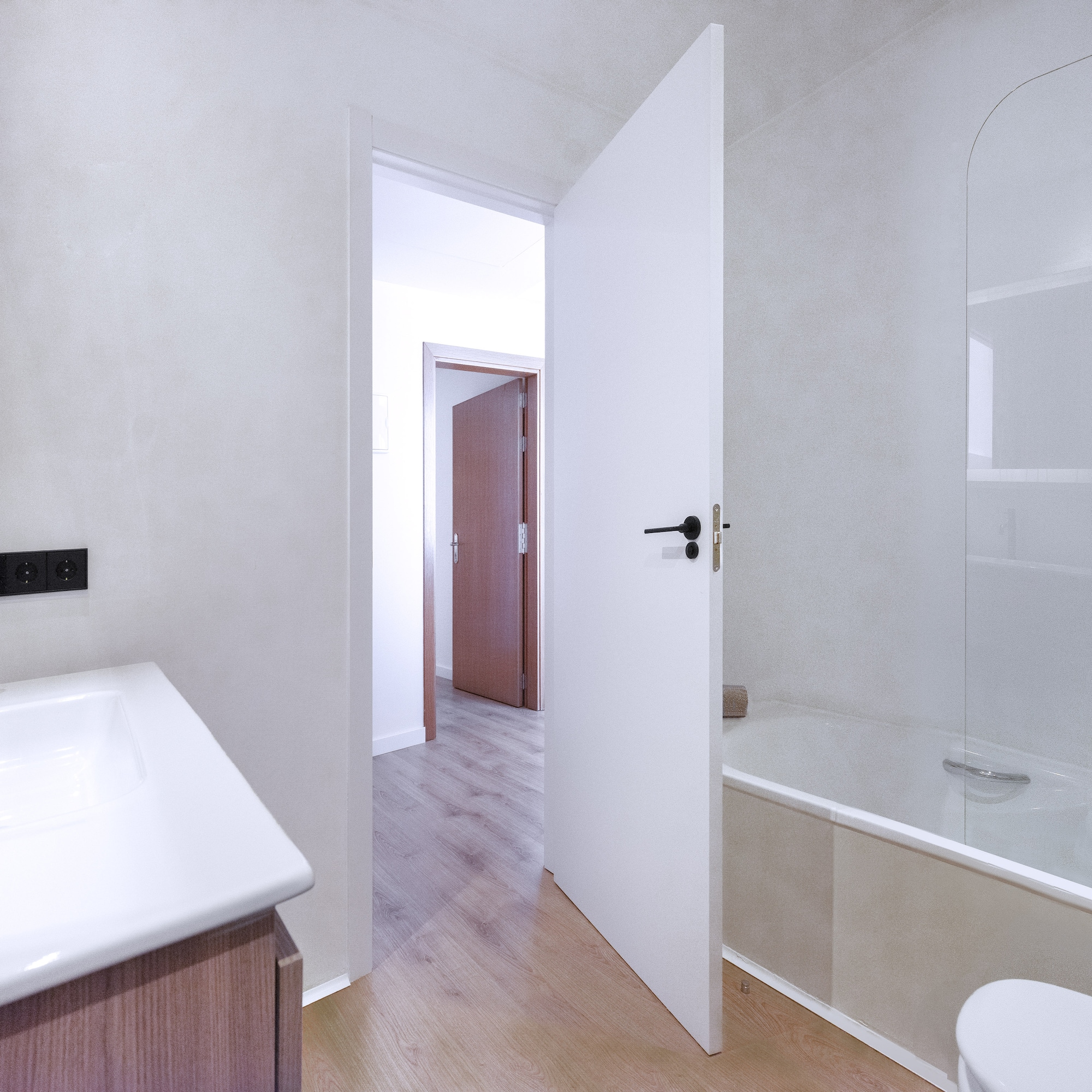 a bathroom with a white door and a bathtub