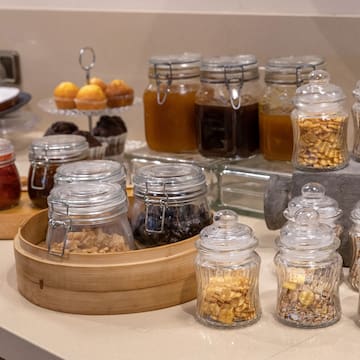 a table with glass jars of food and other food items