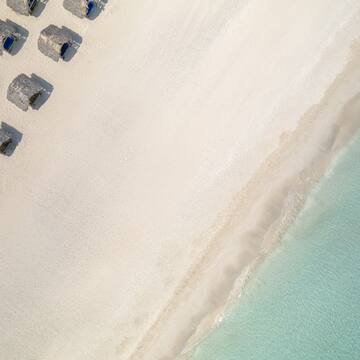 a beach with umbrellas and water