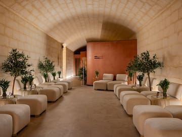 a room with white chairs and tables