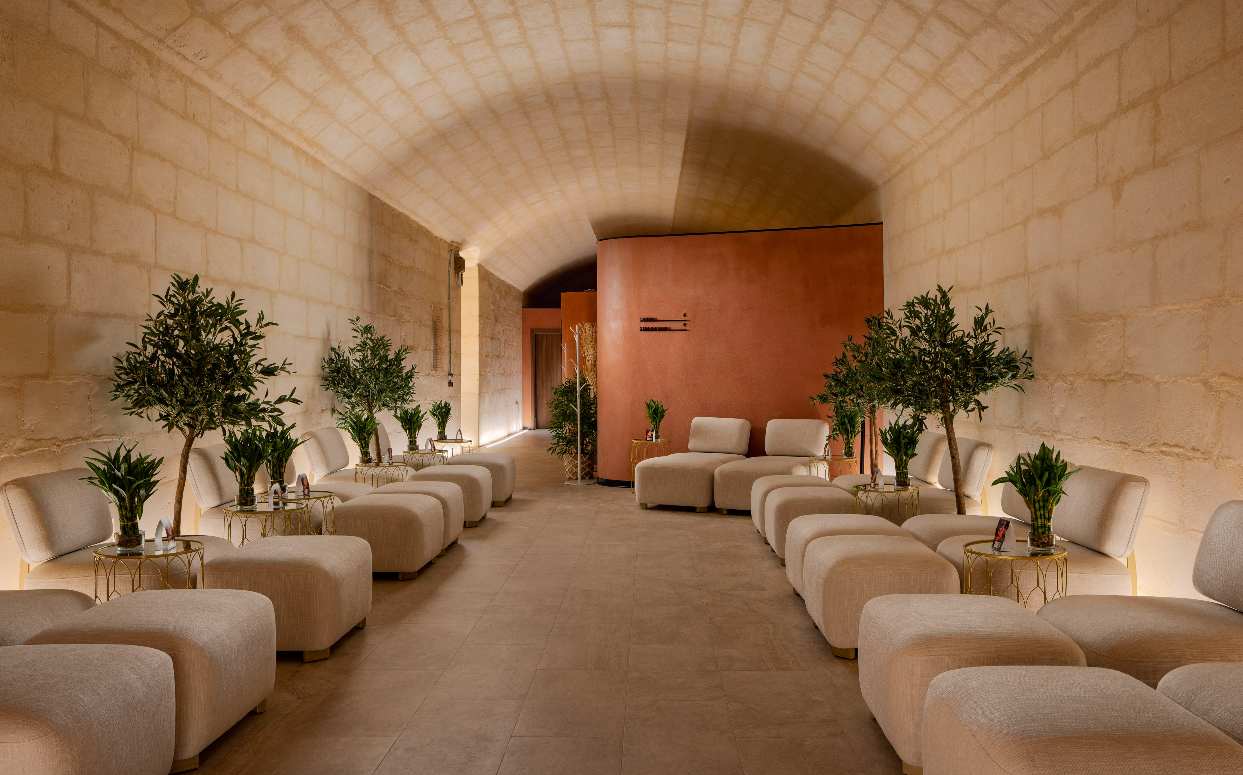a room with white chairs and tables