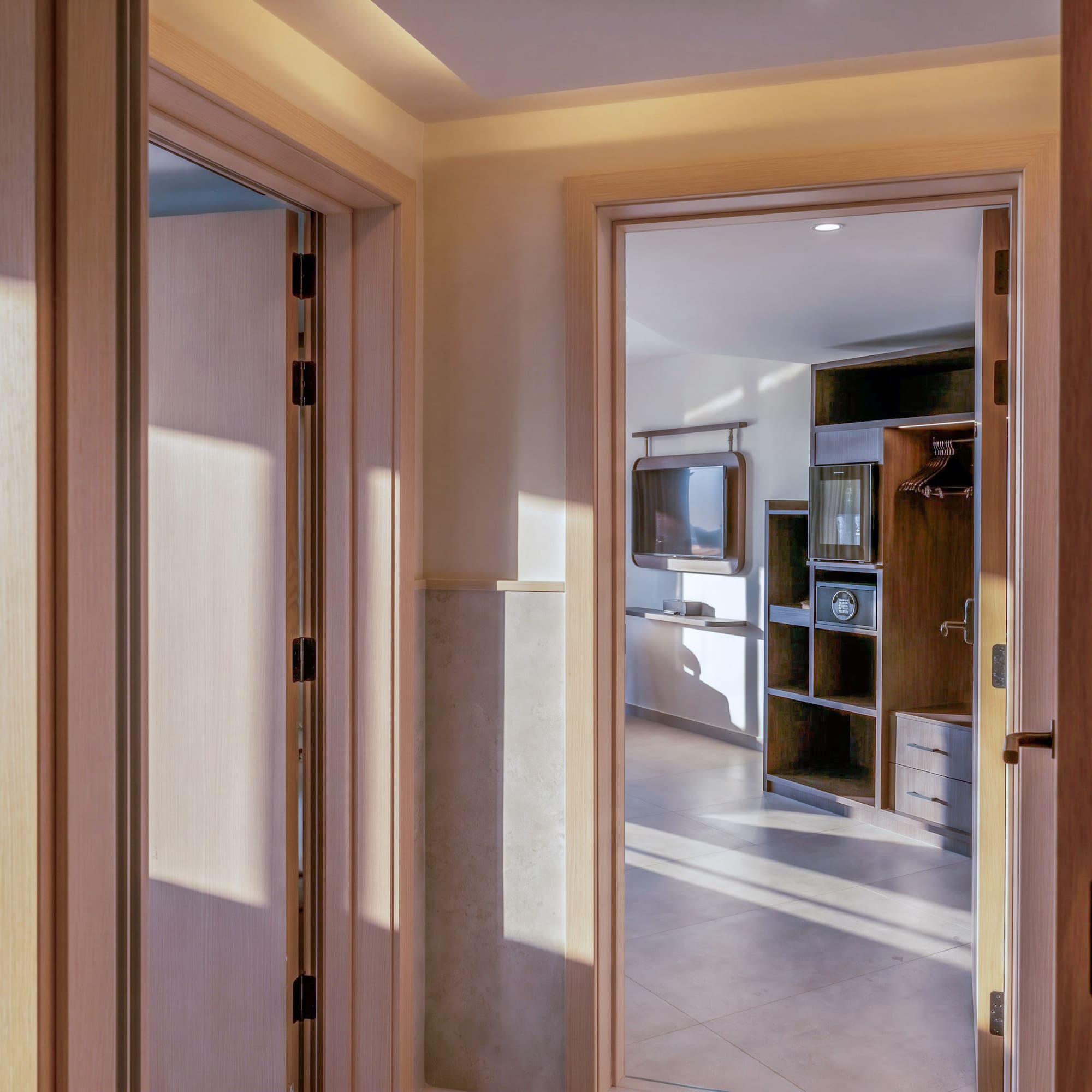 Hotel hallway, room numbers 206, 207, leading to a modern guest room.